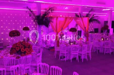 Miniature Location salle Le Raincy (Seine-Saint-Denis) - Le Chalet des Pins #8 Scène de DJ éclairée par des lumières colorées, entourée de rideaux rouges et de haut-parleurs dans une salle.