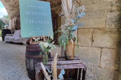 Miniature Location salle Cezais (Vendée) - Château de la Cressonnière #5 Un homme debout, bras ouverts, s'exprime devant un mur en pierre, avec une chaise en bois à côté de lui.