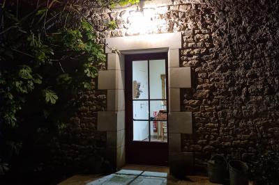 Miniature Location salle Cezais (Vendée) - Château de la Cressonnière #31 Un homme debout, bras ouverts, s'exprime devant un mur en pierre, avec une chaise en bois à côté de lui.