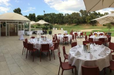 Miniature Location salle Marseille 11 (Bouches-du-Rhône) - La Bastide de la Salette #4 Bâtiment en pierre de style méditerranéen entouré d'arbres, avec une terrasse et une pelouse au premier plan.