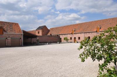 Miniature Location salle Péruwelz (Hainaut) - La Ferme de Bouchegnies #18 Salle de réception en briques avec tables rondes dressées, nappes blanches et décoration de mariage.