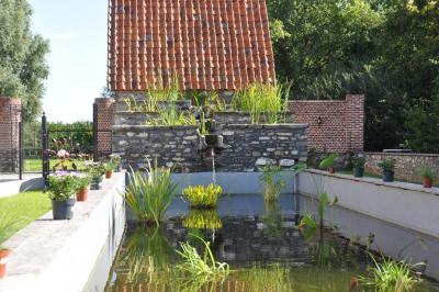 Miniature Location salle Péruwelz (Hainaut) - La Ferme de Bouchegnies #35 Salle de réception en briques avec tables rondes dressées, nappes blanches et décoration de mariage.