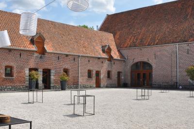 Miniature Location salle Péruwelz (Hainaut) - La Ferme de Bouchegnies #81 Salle de réception en briques avec tables rondes dressées, nappes blanches et décoration de mariage.