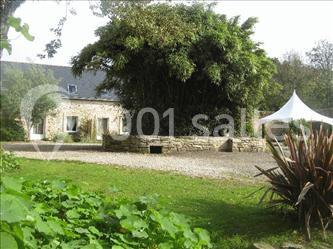 Miniature Location salle Douarnenez (Finistère) - La Ferme de Trézulien #20 Allée ombragée avec banc en bois, hortensias en fleurs et panneaux directionnels près d'un arbre.