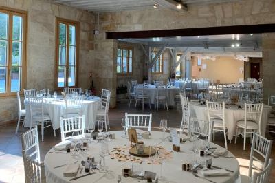 Miniature Location salle Moulis-en-Médoc (Gironde) - Château Maucaillou #20 Salle à manger élégante avec table dressée, bouquet de fleurs au centre, grande fenêtre ouverte sur un jardin verdoyant.