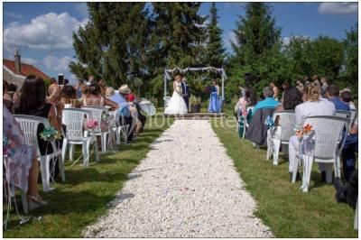 Miniature Location salle Chaumes-en-Brie (Seine-et-Marne) - La Ferme de Forest #22 Un groupe de femmes, dont une en robe blanche, marche sur une pelouse devant un bâtiment en pierre et bois.