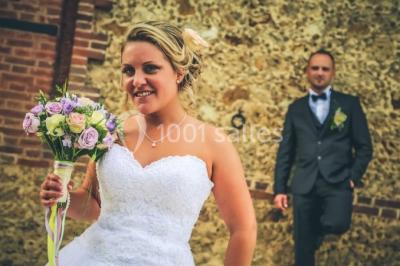 Miniature Location salle Chaumes-en-Brie (Seine-et-Marne) - La Ferme de Forest #30 Un groupe de femmes, dont une en robe blanche, marche sur une pelouse devant un bâtiment en pierre et bois.