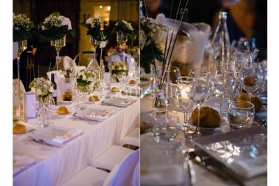 Miniature Location salle Vérargues (Hérault) - Château de Pouget #12 Salle en pierre avec arches, tables décorées et stands alignés, éclairage chaleureux créant une ambiance conviviale.