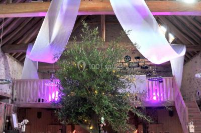 Un tandem décoré de fleurs et d'une caisse en bois, appuyé contre une clôture en bois avec un panneau publicitaire.