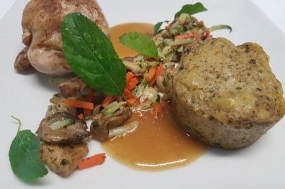 Assiette composée de foie gras, gelée, pain brioché, tranches d'orange, groseilles, jeunes pousses et graines noires.