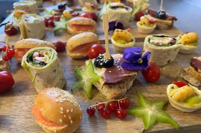 Miniature Traiteur Montauban (Tarn-et-Garonne) - Valérie Pons Traiteur #2 Décoration d'une tente événementielle avec tables ornées, barils en bois, fleurs et ballons dans un espace extérieur.