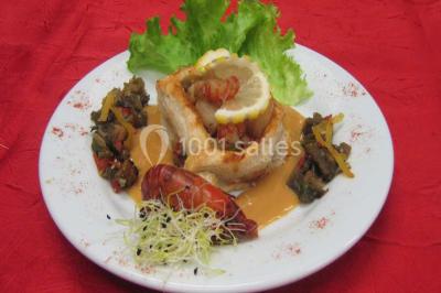 Miniature Traiteur Lezoux (Puy-de-Dôme) - Deneuville Traiteur #5 Pyramide de macarons colorés surmontée de figurines de mariés, présentée sur une table rouge en extérieur.