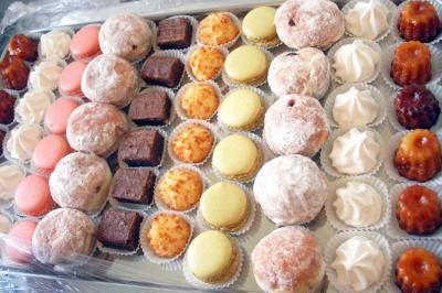 Plateau de bouchées variées comprenant mini-sandwichs, macarons, brochettes, verrines et roulés aux légumes.