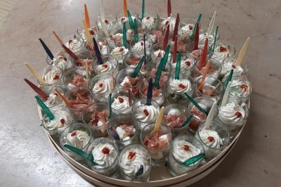 Plateau de canapés variés comprenant des bouchées salées et sucrées, disposées sur une table en inox.