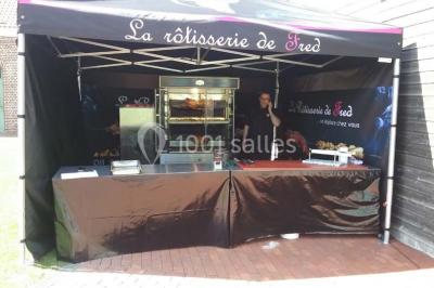Plateau de mini-burgers, bouchées variées et garnitures sur une ardoise noire, présenté sur une nappe sombre.