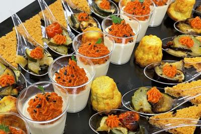 Table décorée pour un repas festif avec nappes blanches, verres, bougies, décorations végétales et petits cadeaux.