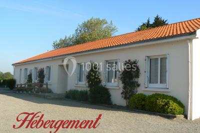 Miniature Location salle Chéméré (Loire-Atlantique) - La Baronnerie #15 Tente blanche montée sur une pelouse, équipée de tables hautes, devant un bâtiment clair et des arbres.