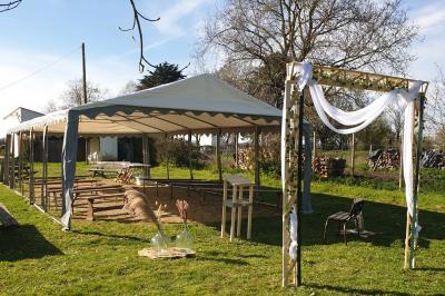 Miniature Location salle Chéméré (Loire-Atlantique) - La Baronnerie #14 Tente blanche montée sur une pelouse, équipée de tables hautes, devant un bâtiment clair et des arbres.