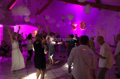 Miniature DJ Le Val (Var) - Enjoy-Your-Event #3 Personnes discutant dans une salle éclairée de lumières bleues, avec tables de buffet et décoration festive.