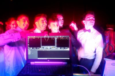 Miniature DJ Pau (Pyrénées-Atlantiques) - DJ Kasimodo #13 Des personnes souriantes lèvent les bras et posent devant un écran dans une ambiance festive en intérieur.