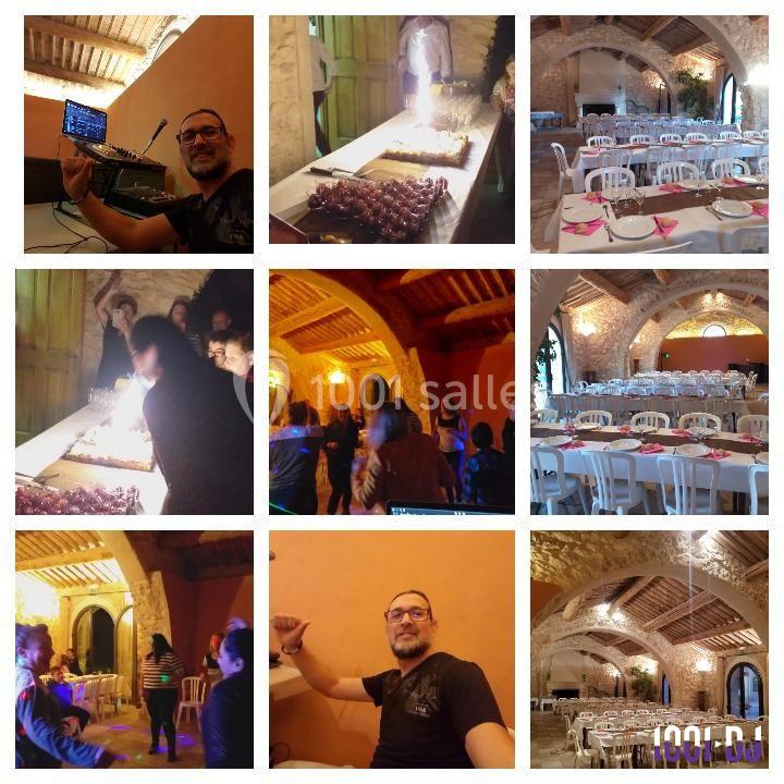 Salle en pierre avec tables dressées, ambiance festive, personnes célébrant autour d'un gâteau illuminé.