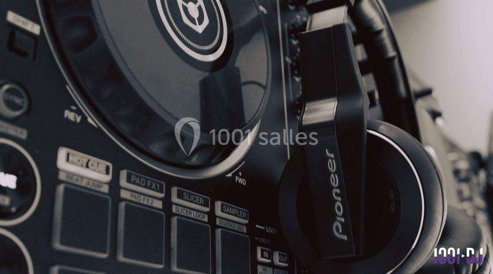 Casque audio Pioneer accroché à une table de mixage avec des boutons et commandes visibles en gros plan.