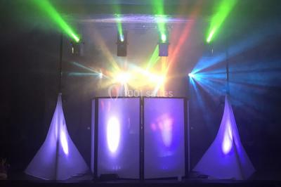 Table de mixage DJ avec platines lumineuses et un ordinateur portable affichant un logiciel de mixage.