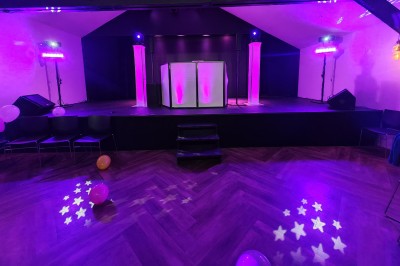 Miniature DJ Villiers-le-Bel (Val-d'Oise) - Gass Prod & Events #27 Scène éclairée de lumières violettes avec une piste de danse en parquet et des ballons au sol.