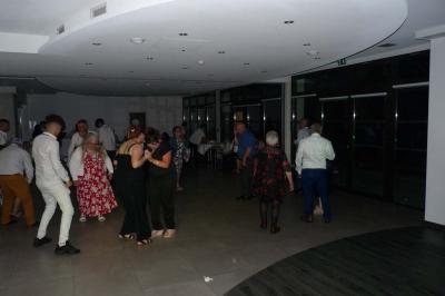 Salle décorée avec table dressée, matériel de sonorisation et panneau promotionnel pour des événements festifs.
