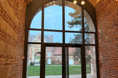 Miniature Location salle Esnes (Nord) - Domaine du Château d’Esnes #5 Comptoir noir devant un mur rouge décoré de motifs floraux, éclairé par des suspensions dans un espace à la décoration…