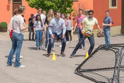 Un groupe de personnes en tenue formelle pose sur une scène lors d'un événement avec un écran affichant des logos en arrière…