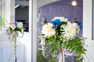 Table décorée avec des fleurs blanches, des ornements royaux ’Queen’ et ’King’, et un fond scintillant.