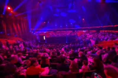 Miniature Location salle Lille (Nord) - Chapiteaux Arlette Gruss - Lille #12 Personnes dansant sous des éclairages colorés dans une salle sombre avec des gradins en arrière-plan.
