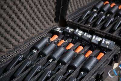 Flammes vives s'élevant d'un feu de bois sous une grille métallique, entourées de pierres sombres.