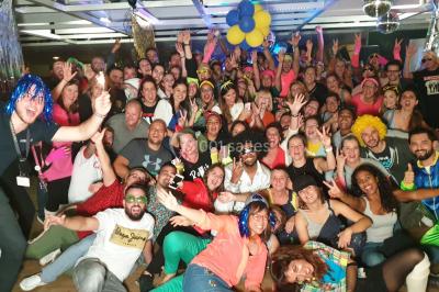 Flammes vives s'élevant d'un feu de bois sous une grille métallique, entourées de pierres sombres.