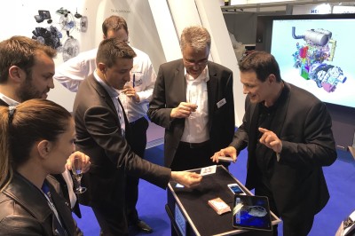 Miniature Martial Magicien Digital Mentaliste #3 Un homme en costume tenant une tablette affichant des applications, avec un smartphone placé devant l'écran.