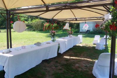 Miniature Location salle Ornacieux (Isère) - Domaine du Moulin Piongo #17 Chambre lumineuse avec lits en bois, bureau, armoire, décorations végétales et vue sur un jardin par la fenêtre.