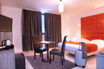 Vue d'un terrain de golf verdoyant avec des arbres et une ville en arrière-plan sous un ciel dégagé.