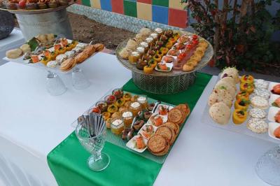 Lettres rouges formant le mot ’LOVE’ sur un tapis rouge, entourées de petites décorations blanches, en extérieur.