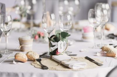 Miniature Location salle Argueil (Seine-Maritime) - Domaine de Clairval #11 Lit double avec tête de lit sombre, draps gris et blancs, encadré par deux tables de chevet avec lampes, dans une chambre…