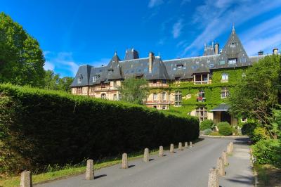 Miniature Location salle Gouvieux (Oise) - Château Jeanne & The Forest - Château de Montvillargenne #3 Un couple en tenue de mariage se tient devant une porte illuminée, entouré de briques et de végétation.