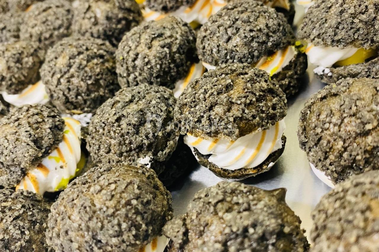 Location salle Bonneval (Eure-et-Loir) - Auberge de La Herse #19 Choux noirs garnis de crème blanche et filet de caramel, disposés sur un plateau argenté.