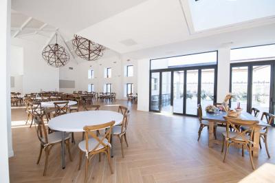 Miniature Location salle Artigues (Var) - Domaine de la Mongestine #29 Bouteille de vin rosé entourée de verres vides sur une table en bois, avec une plante en arrière-plan.