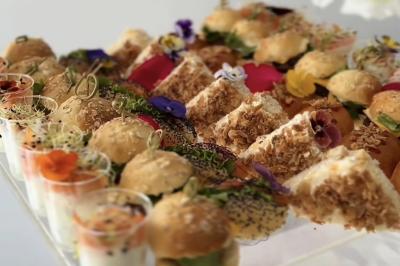 Miniature Location salle Boulogne-Billancourt (Hauts-de-Seine) - La Péniche So Chic #54 Plateau de mini-sandwichs variés, verrines et décorations florales comestibles, présenté sur une table.