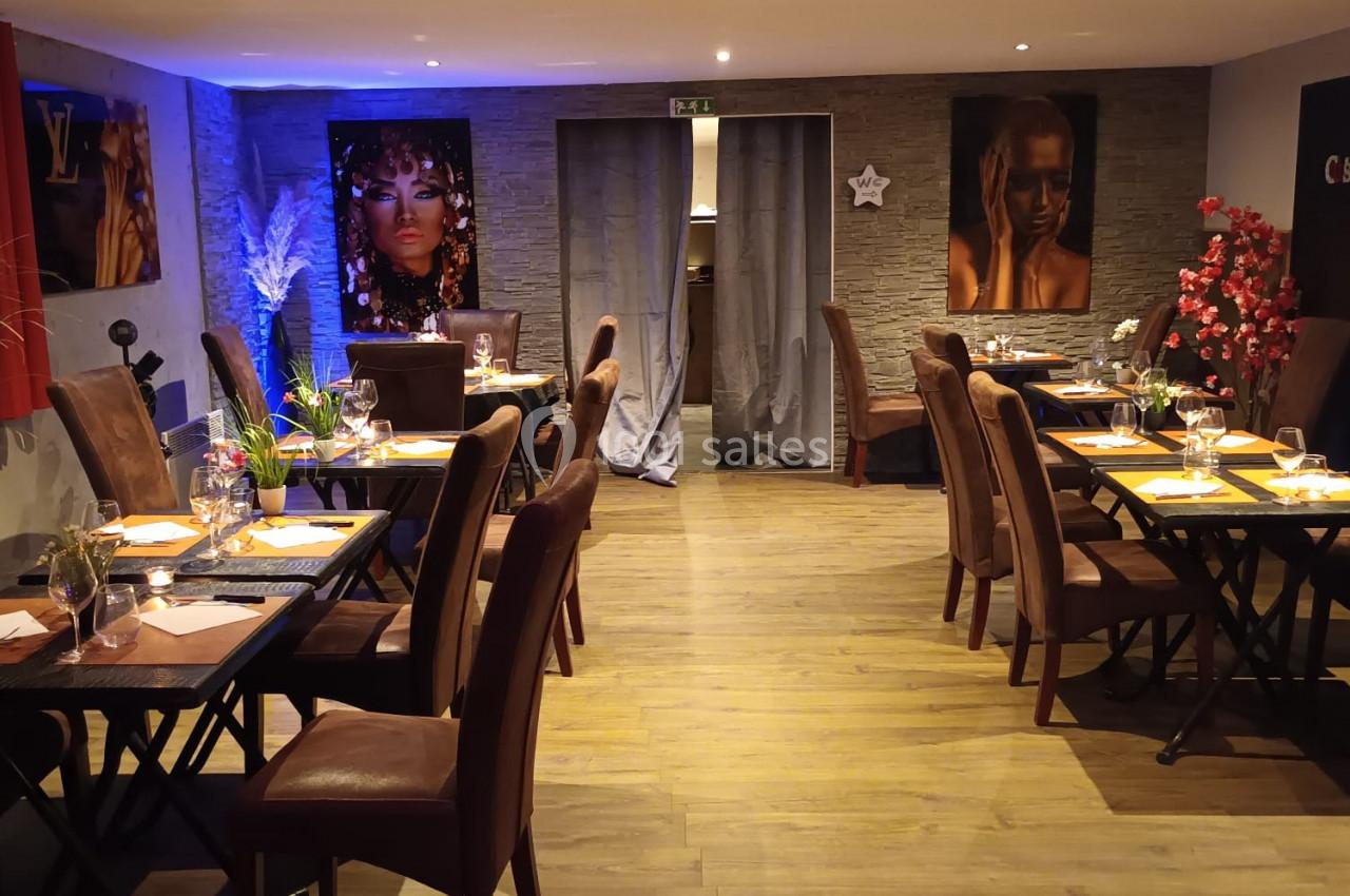 Location salle Hem (Nord) - O'Green du Château d'Hem #4 Salle de restaurant chaleureuse avec tables dressées, éclairage tamisé et décorations murales colorées.