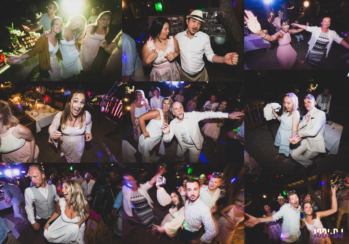 Des personnes dansent et s'amusent lors d'une fête animée avec éclairages colorés et ambiance festive.