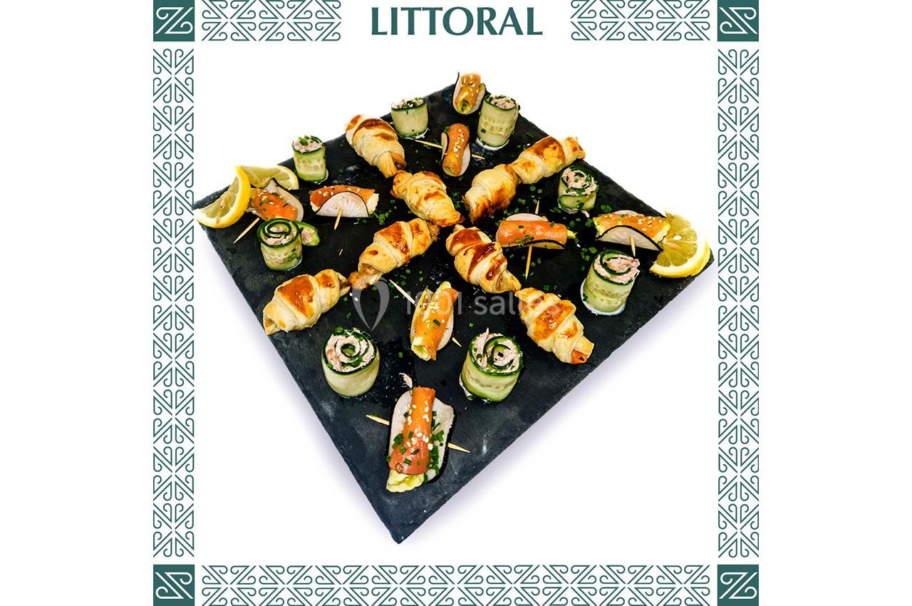 Plateau de bouchées apéritives variées, incluant croissants, roulés de légumes et saumon, décoré de citron.