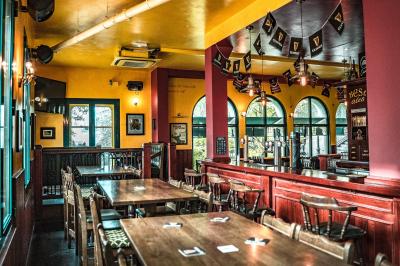 Miniature Location salle Paris 18 (Paris) - Corcoran's Sacré Coeur #17 Façade d'un pub irlandais avec enseignes vertes, drapeau irlandais et arbres aux feuilles d'automne.