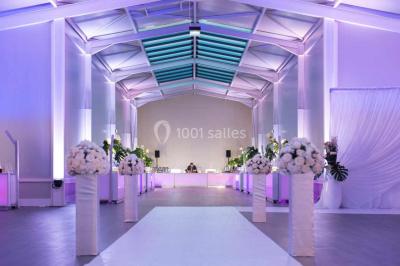 Piscine éclairée de nuit entourée de chaises longues, avec une terrasse en premier plan et des bougies allumées.