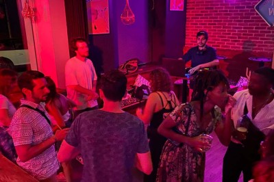 Miniature Location salle Lille (Nord) - Barnett's #3 Deux personnes souriantes dans un café à l'ambiance chaleureuse, avec un mur en briques et une enseigne néon.